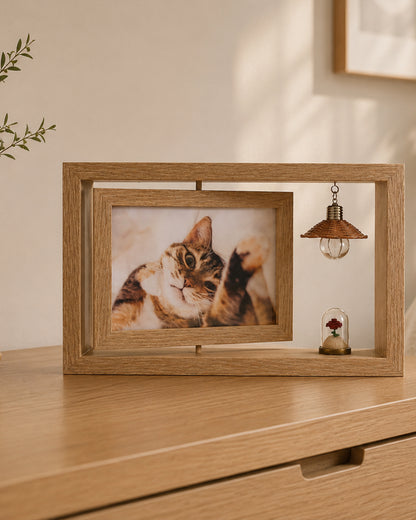 Beige 7-inch personalized pet memorial frame with a cat photo, soft hanging light, and rose keepsake displayed on a warm modern bedside cabinet.