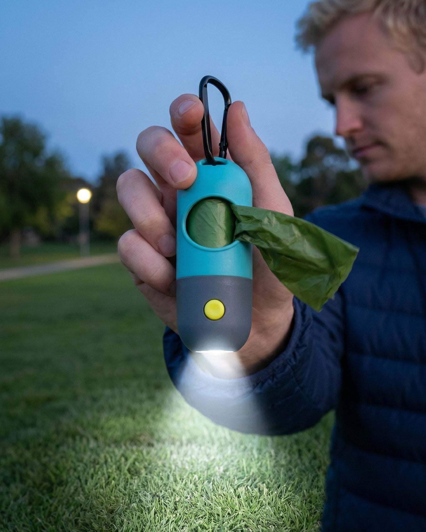 Trailblaze Glow Waste Capsule shining built-in light during a nighttime dog walk