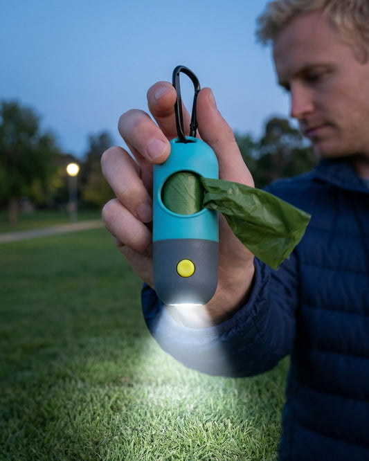Trailblaze Glow Waste Capsule shining built-in light during a nighttime dog walk