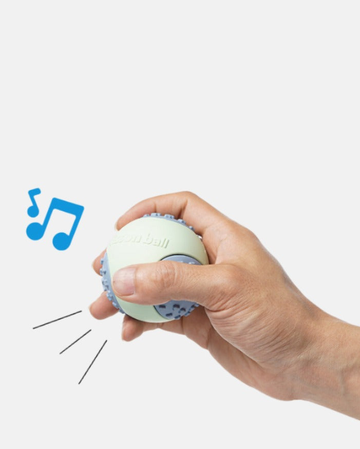 ChewFlex Fetch Ball squeaky dog ball sound feature shown by hand squeeze