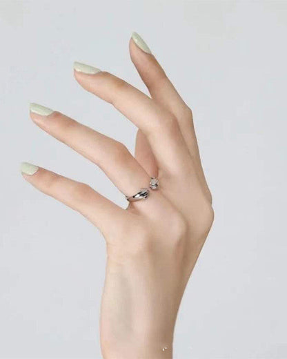 Still With Me pawprint ring worn on hand in a clean minimal lifestyle photo