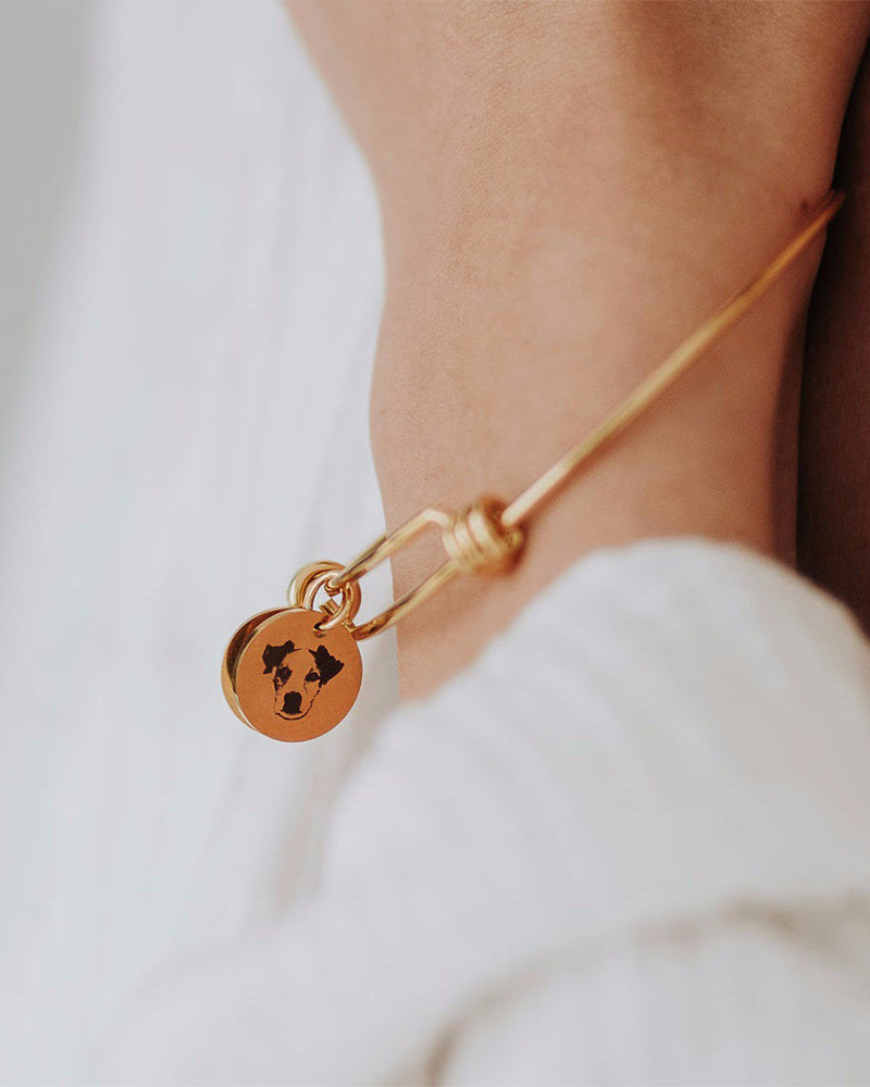 Close-up of Still With Me portrait bracelet charm with pet portrait engraving