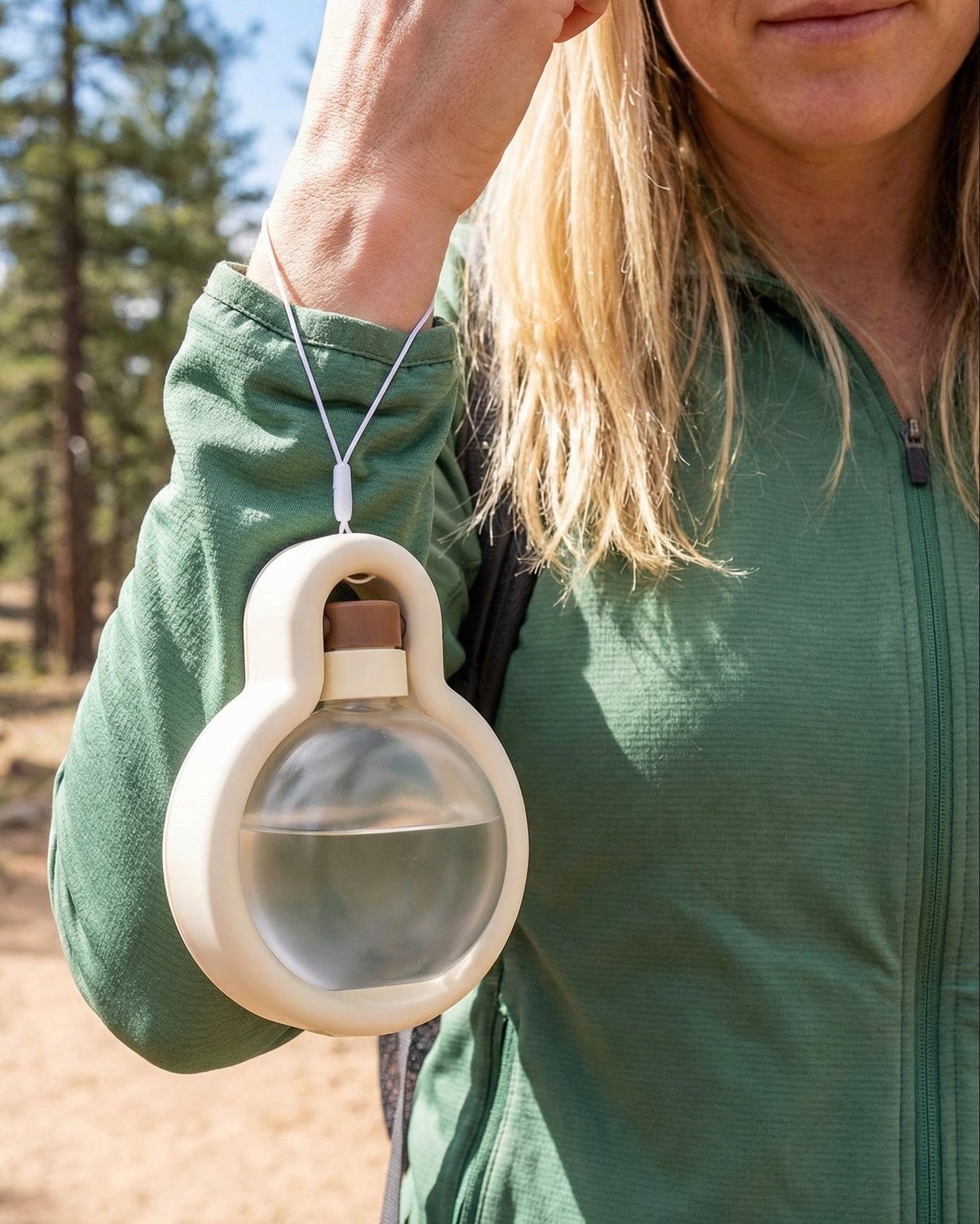 Person carrying Trailblaze Hydration Hub pet water bottle for travel and daily outings