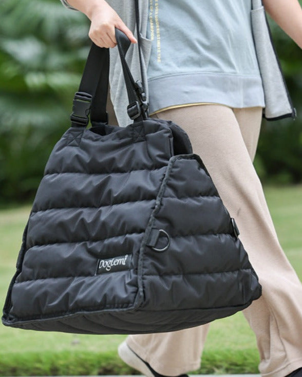 Voyager Cozy Carrier carried by hand as a padded travel bag for pets
