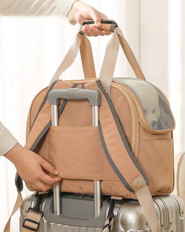 Voyager Flex Carrier attached to a suitcase handle with luggage strap for travel