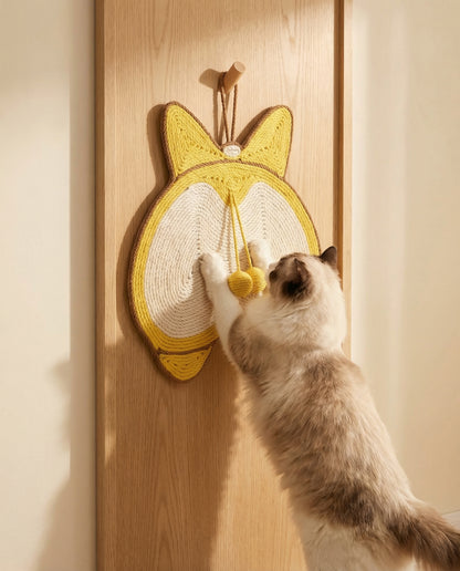 Cat scratching WhiskerBloom Corgi Sisal Scratch Pad hung on a wall or door