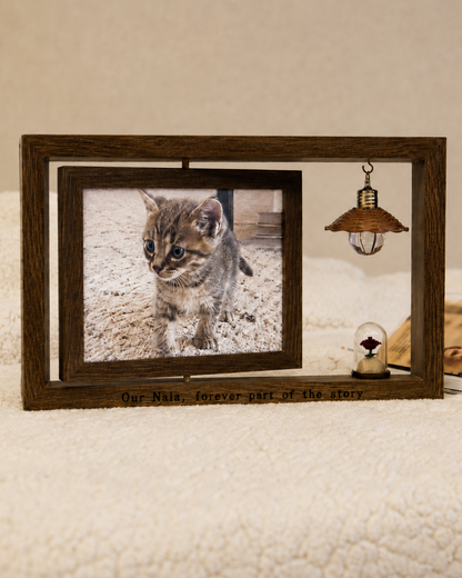 Walnut personalized pet memorial frame with a kitten photo, custom engraving reading “Our Nala, forever part of the story,” a hanging light, and a rose keepsake vial.